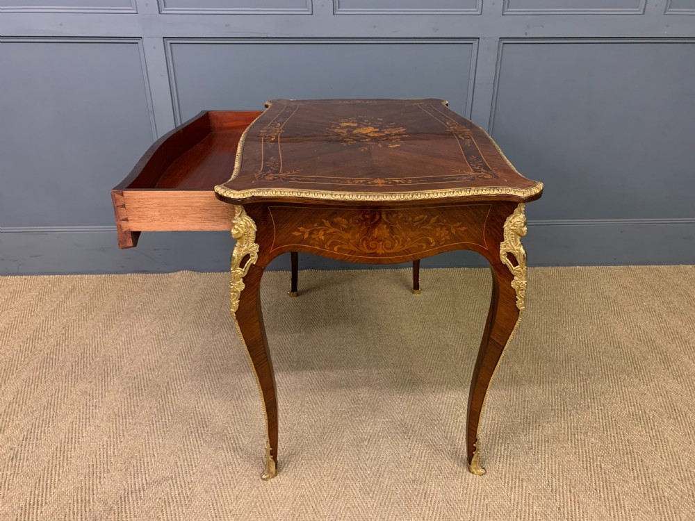 An antique rosewood occasional table featuring floral marquetry inlays across the serpentine top and apron, supported by cabriole legs with gilt-bronze ormolu mounts. View XIV