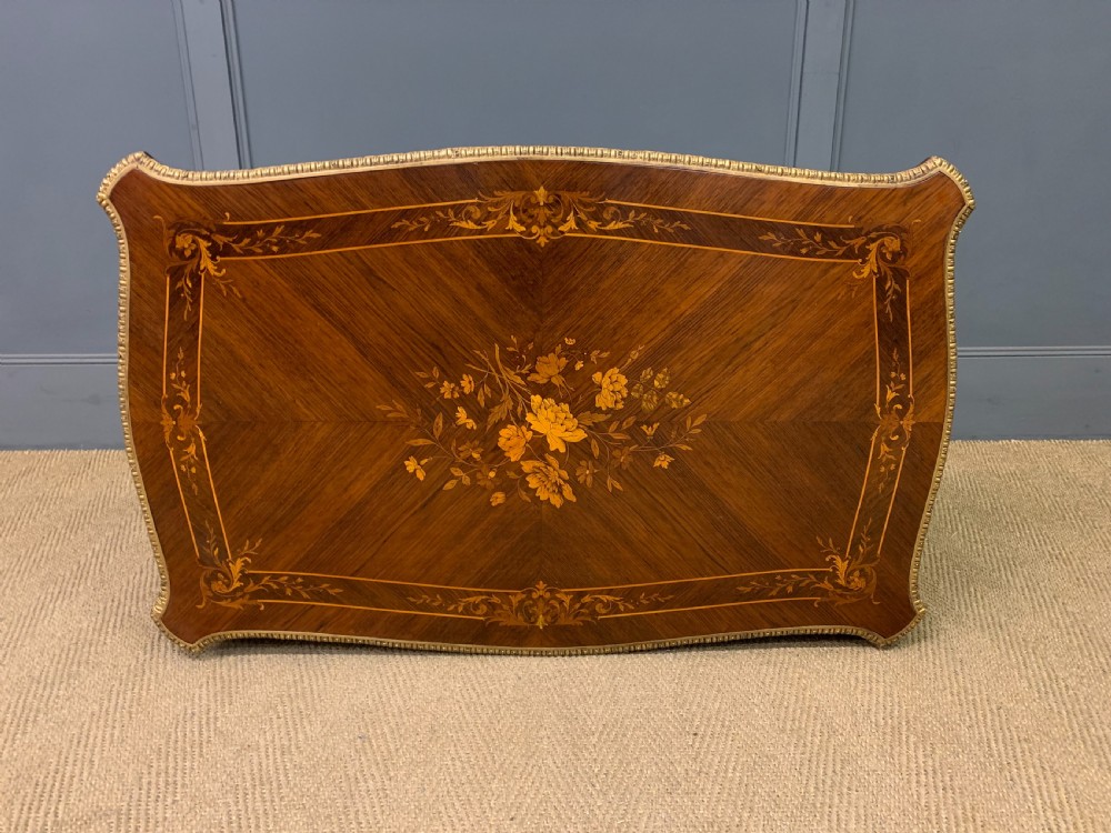An antique rosewood occasional table featuring floral marquetry inlays across the serpentine top and apron, supported by cabriole legs with gilt-bronze ormolu mounts. View XVI