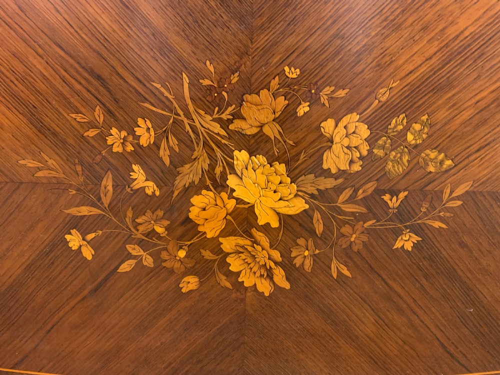 An antique rosewood occasional table featuring floral marquetry inlays across the serpentine top and apron, supported by cabriole legs with gilt-bronze ormolu mounts. View XVII