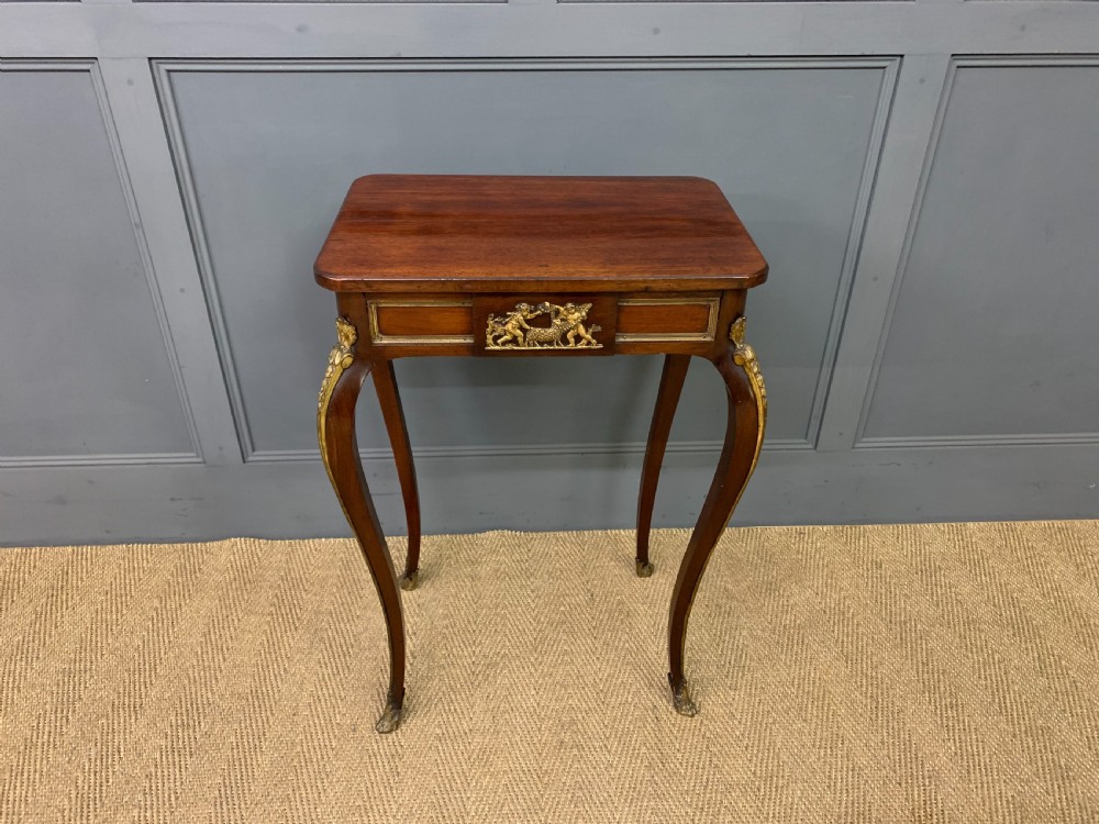 A rectangular dark mahogany side table featuring slender cabriole legs, gilt bronze corner mounts, and a decorative ormolu relief plaque on the frieze. View II