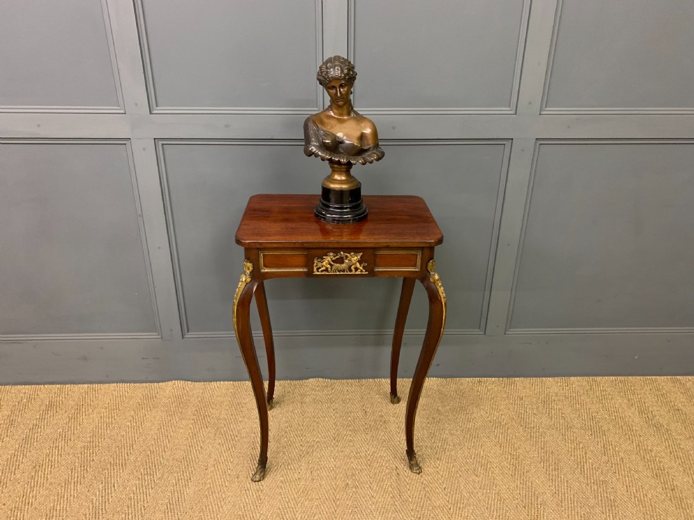 A rectangular dark mahogany side table featuring slender cabriole legs, gilt bronze corner mounts, and a decorative ormolu relief plaque on the frieze. View IX