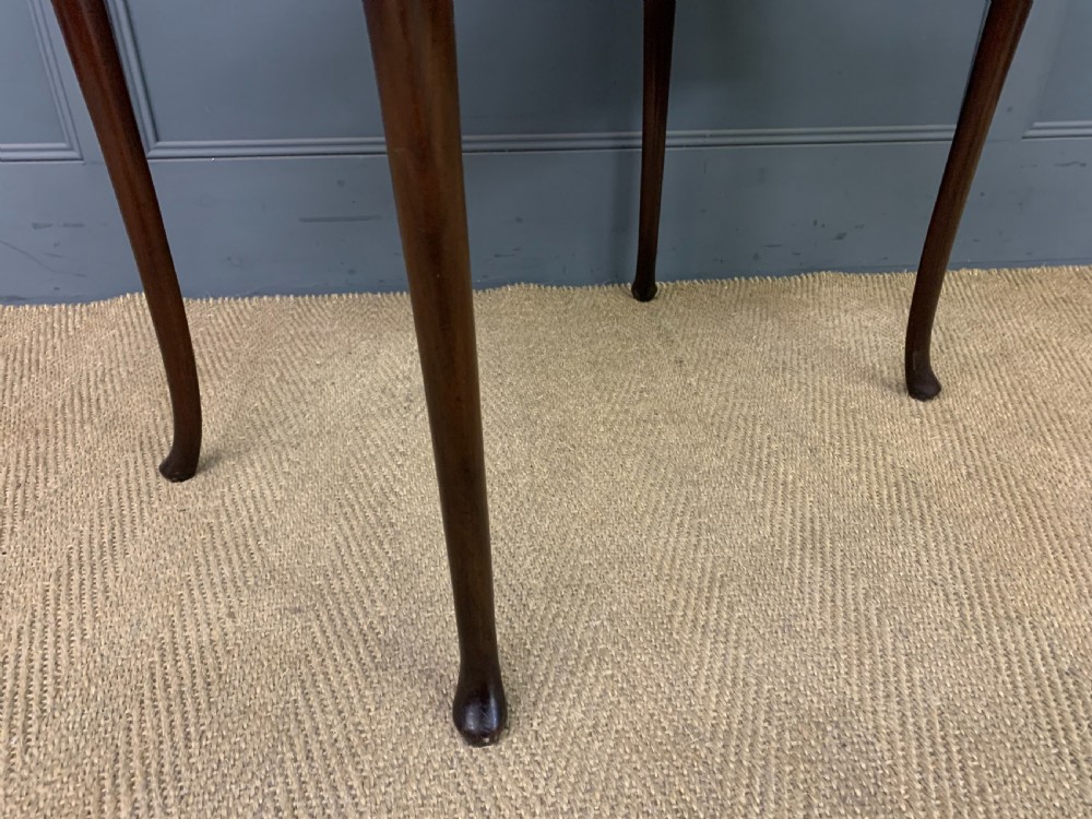A mahogany bijouterie table featuring a glazed glass top and sides, green fabric interior lining, cabriole legs, and carved shell details on the knees. View VII