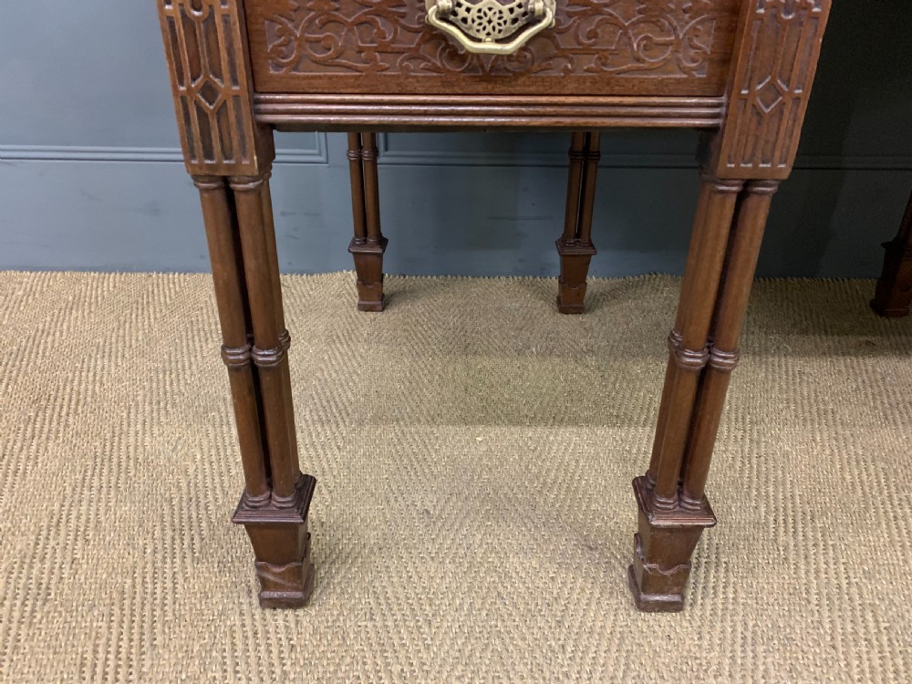 Victorian mahogany writing desk featuring a gallery superstructure with pierced fretwork, a brown leather inset surface, and multiple drawers with brass drop handles. View IV