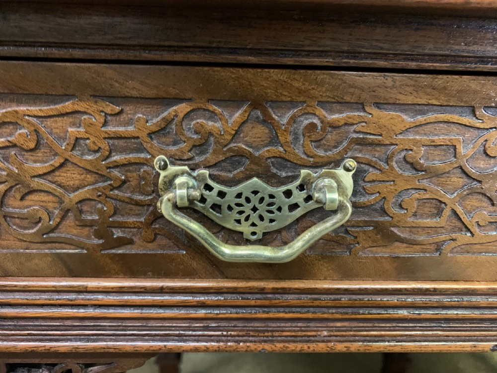 Victorian mahogany writing desk featuring a gallery superstructure with pierced fretwork, a brown leather inset surface, and multiple drawers with brass drop handles. View VIII