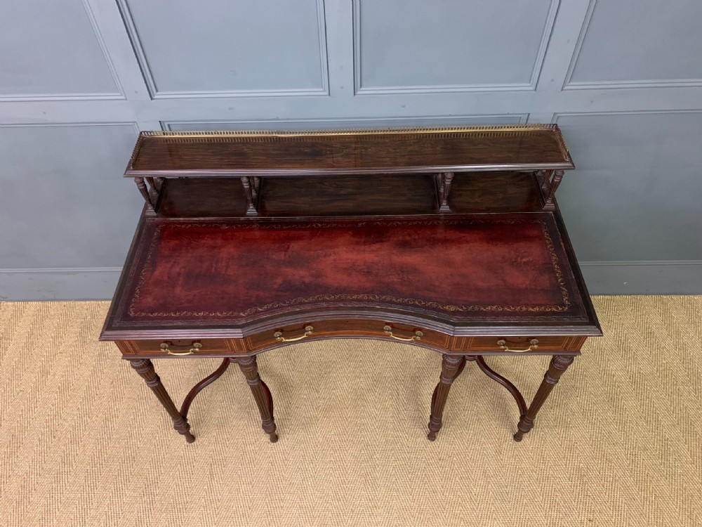 A late Victorian mahogany writing desk by Collinson and Lock with a raised upper shelf gallery, leather top, satinwood inlay, and turned legs. View III