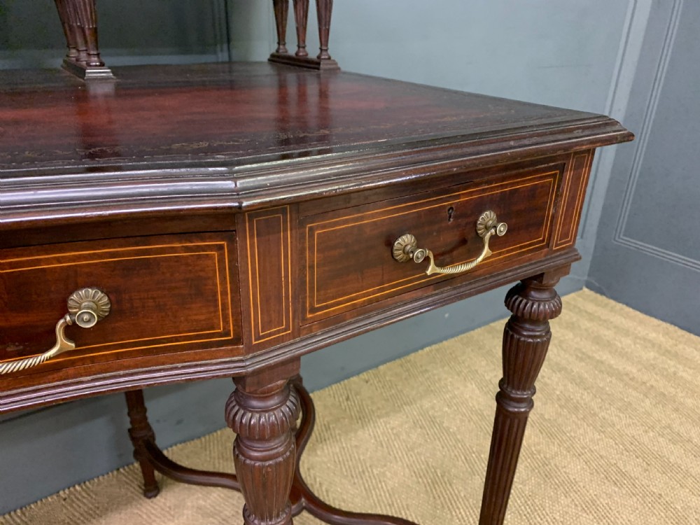 A late Victorian mahogany writing desk by Collinson and Lock with a raised upper shelf gallery, leather top, satinwood inlay, and turned legs. View VI