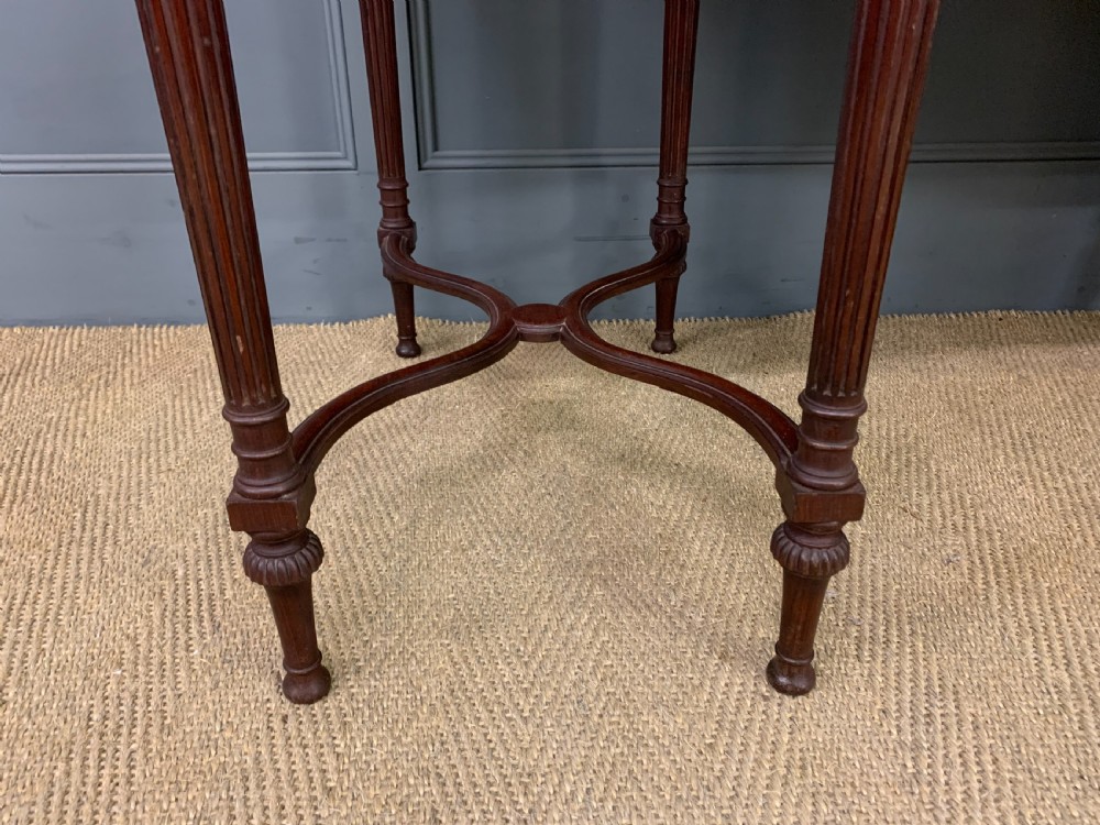A late Victorian mahogany writing desk by Collinson and Lock with a raised upper shelf gallery, leather top, satinwood inlay, and turned legs. View VIII