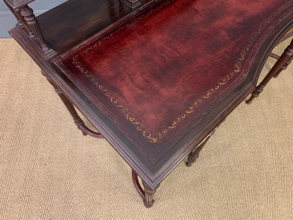 A late Victorian mahogany writing desk by Collinson and Lock with a raised upper shelf gallery, leather top, satinwood inlay, and turned legs. View XIV