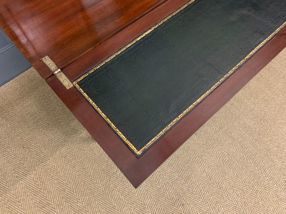 An Edwardian inlaid mahogany bonheur du jour writing desk featuring a central arched mirror, twin side cabinets with oval marquetry, brass galleries, and a lower shelf over tapered legs. View VIII