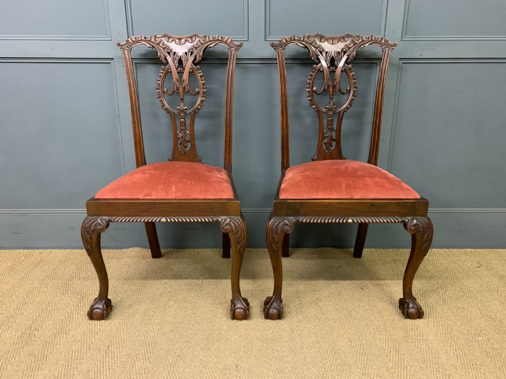 A pair of Chippendale style mahogany side chairs featuring intricate pierced back splats, cabriole legs with ball and claw feet, and terracotta velvet upholstered seats. View II