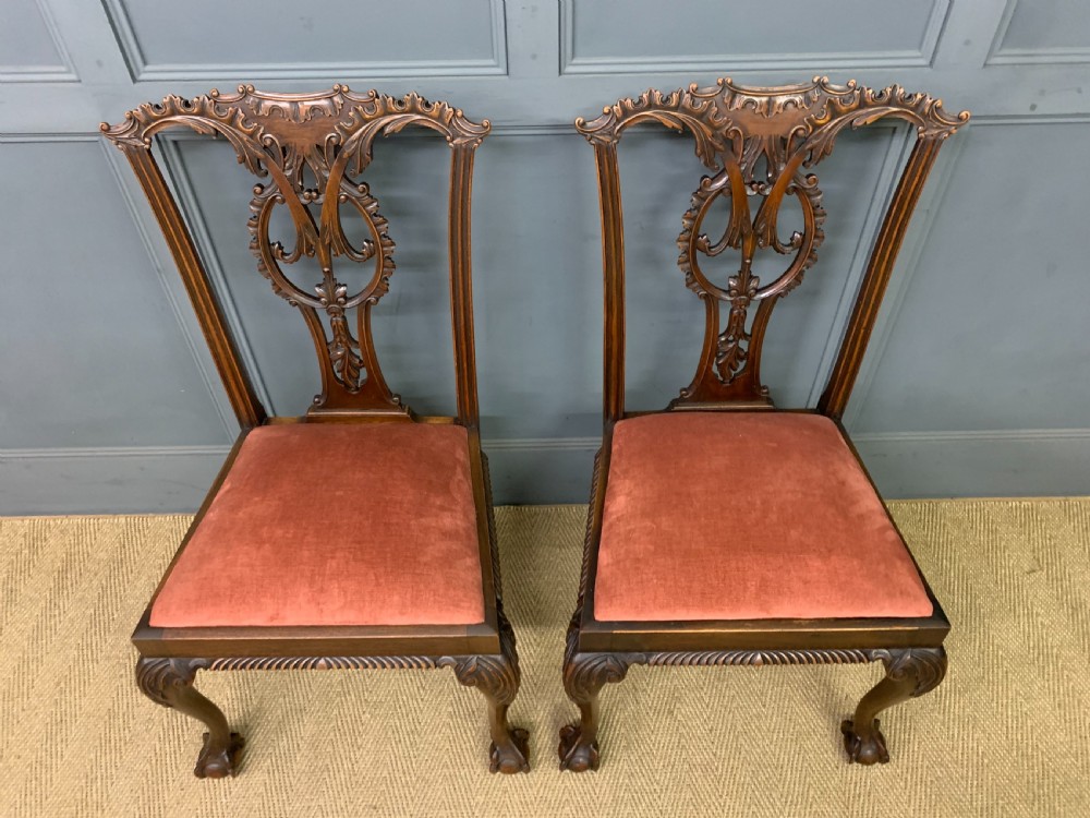 A pair of Chippendale style mahogany side chairs featuring intricate pierced back splats, cabriole legs with ball and claw feet, and terracotta velvet upholstered seats. View III