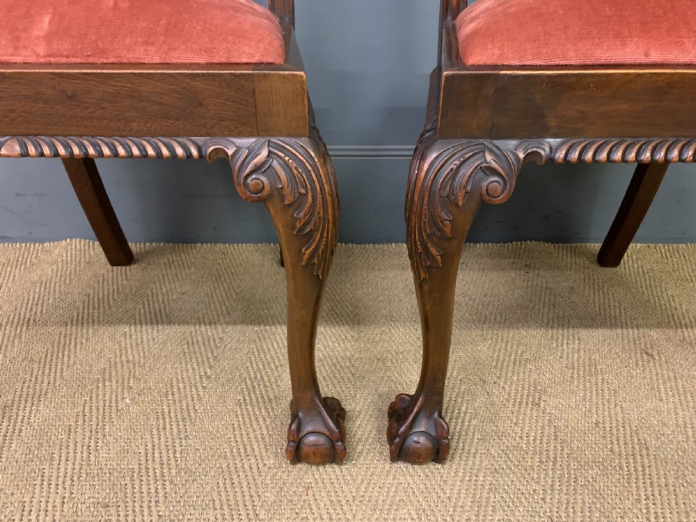 A pair of Chippendale style mahogany side chairs featuring intricate pierced back splats, cabriole legs with ball and claw feet, and terracotta velvet upholstered seats. View IV