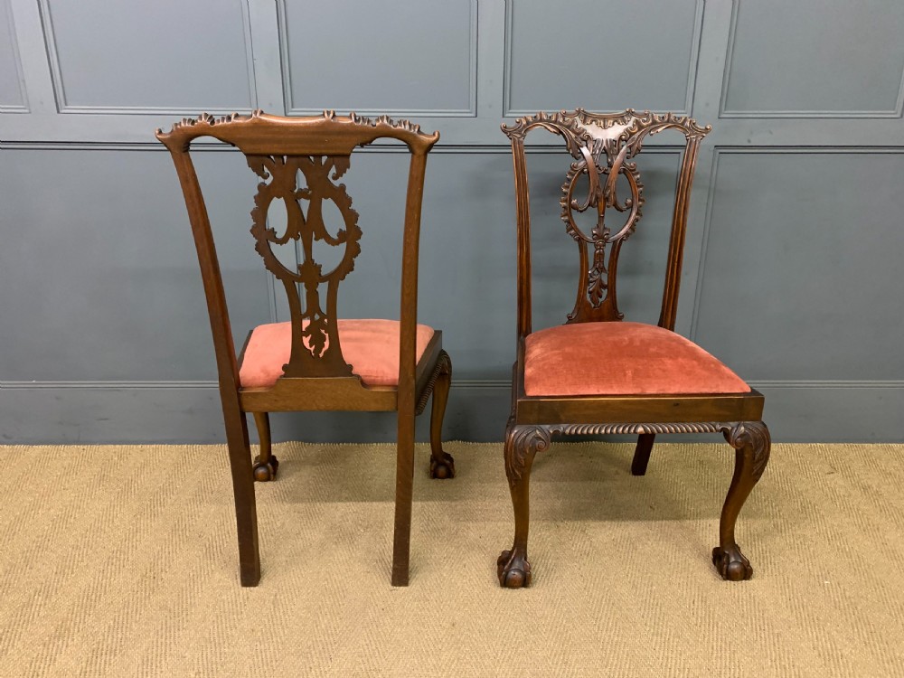 A pair of Chippendale style mahogany side chairs featuring intricate pierced back splats, cabriole legs with ball and claw feet, and terracotta velvet upholstered seats. View VII