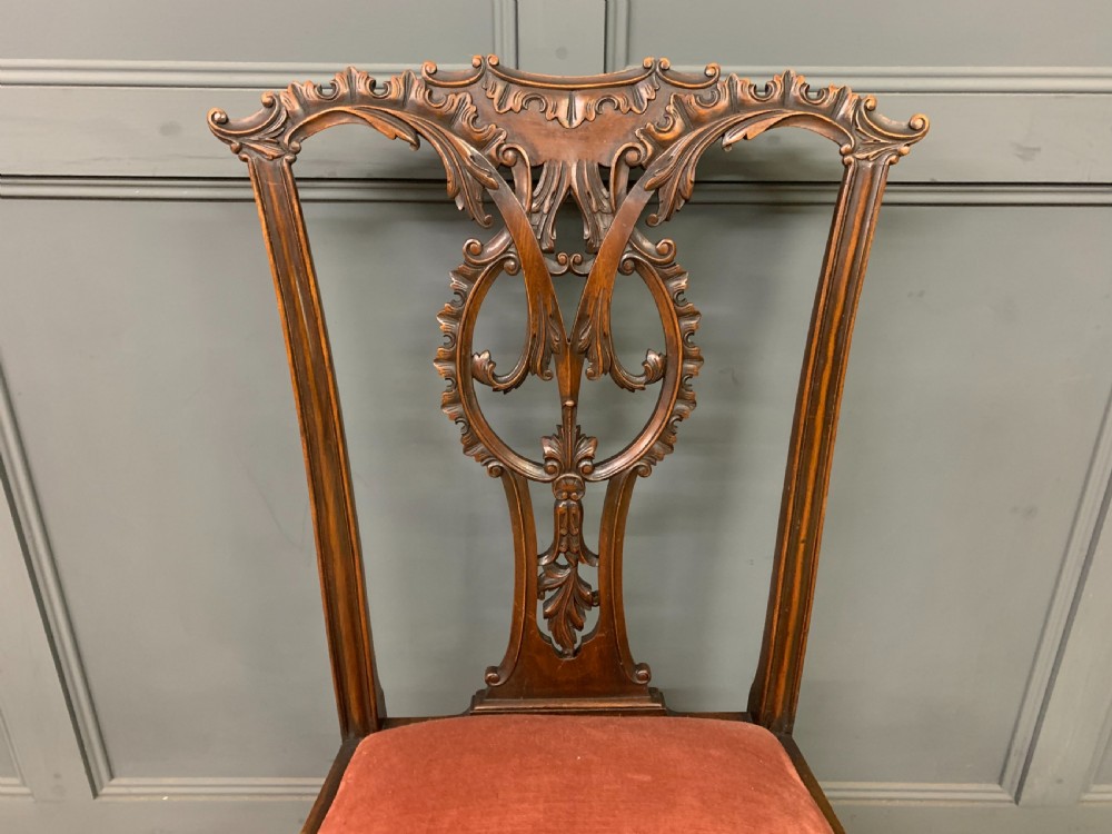 A pair of Chippendale style mahogany side chairs featuring intricate pierced back splats, cabriole legs with ball and claw feet, and terracotta velvet upholstered seats. View VIII