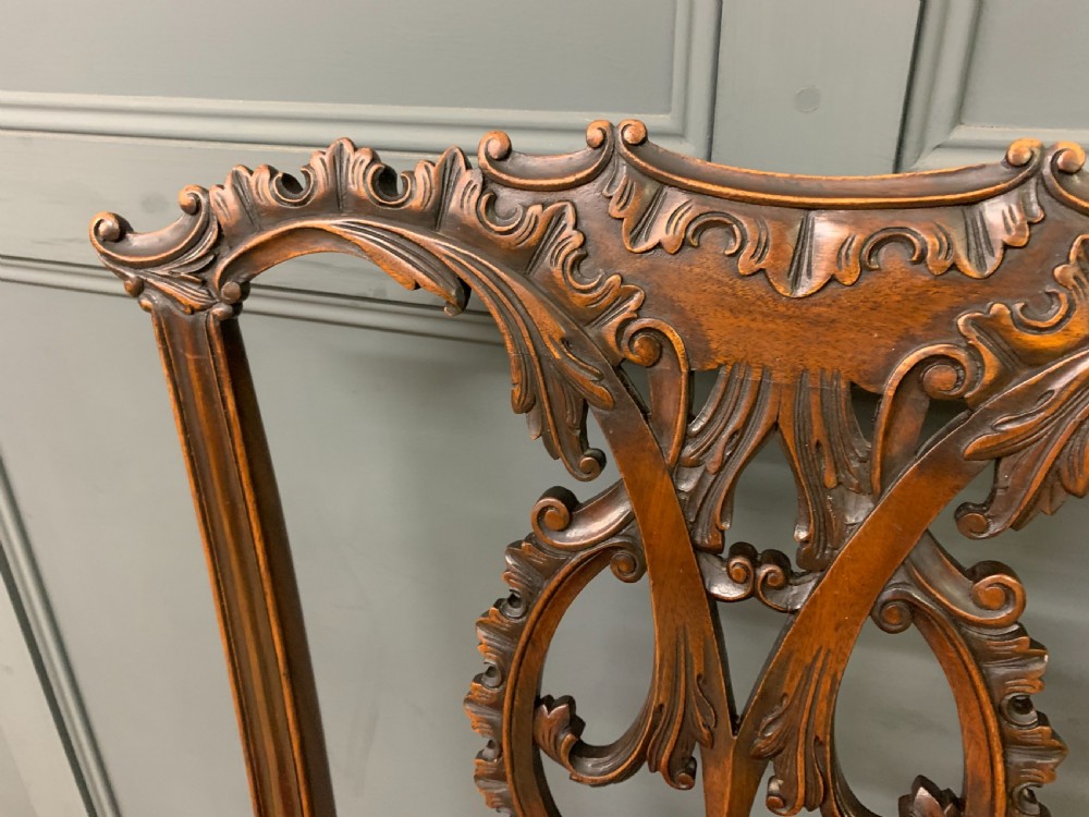 A pair of Chippendale style mahogany side chairs featuring intricate pierced back splats, cabriole legs with ball and claw feet, and terracotta velvet upholstered seats. View IX