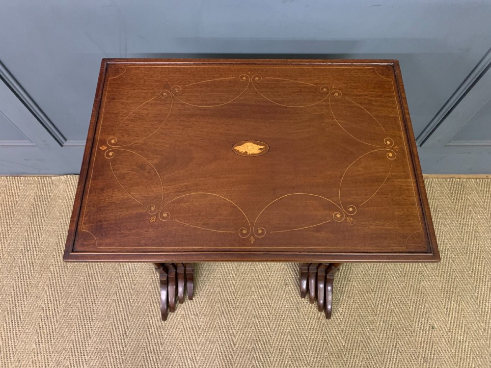 A set of four graduating mahogany nest of tables featuring satinwood line inlay and slender turned legs. View IV