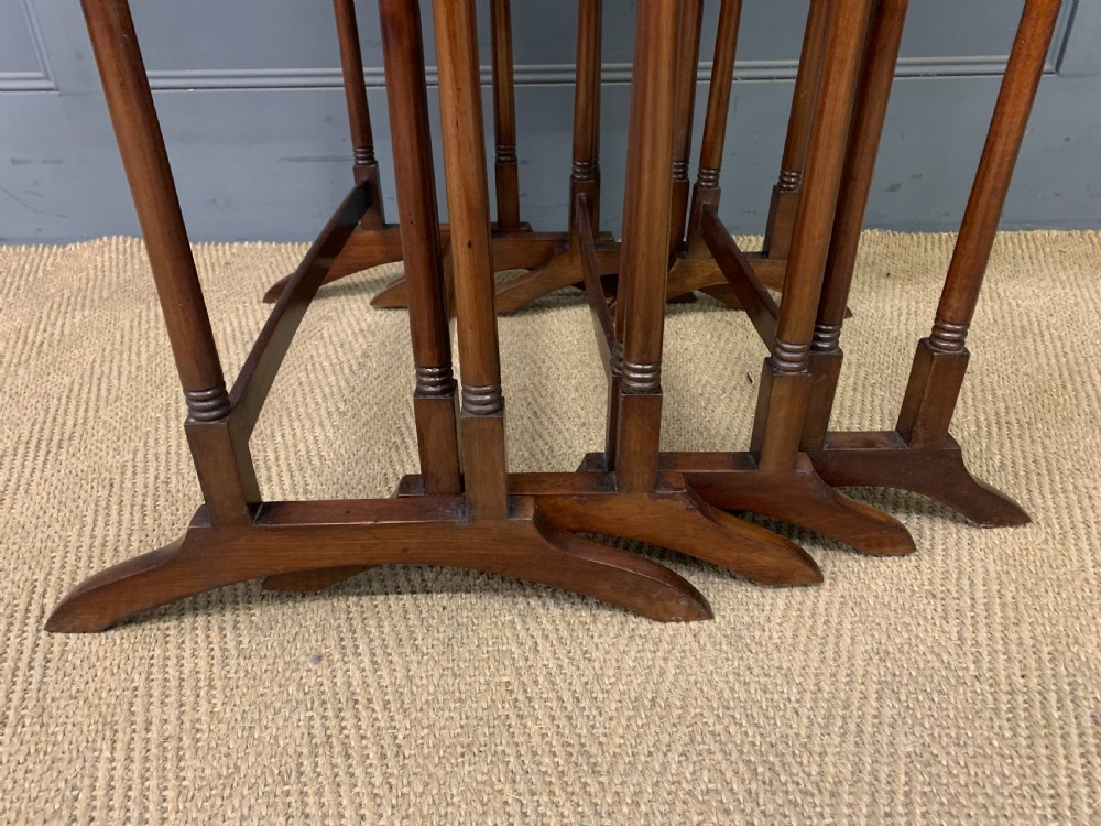 A set of four graduating mahogany nest of tables featuring satinwood line inlay and slender turned legs. View IX