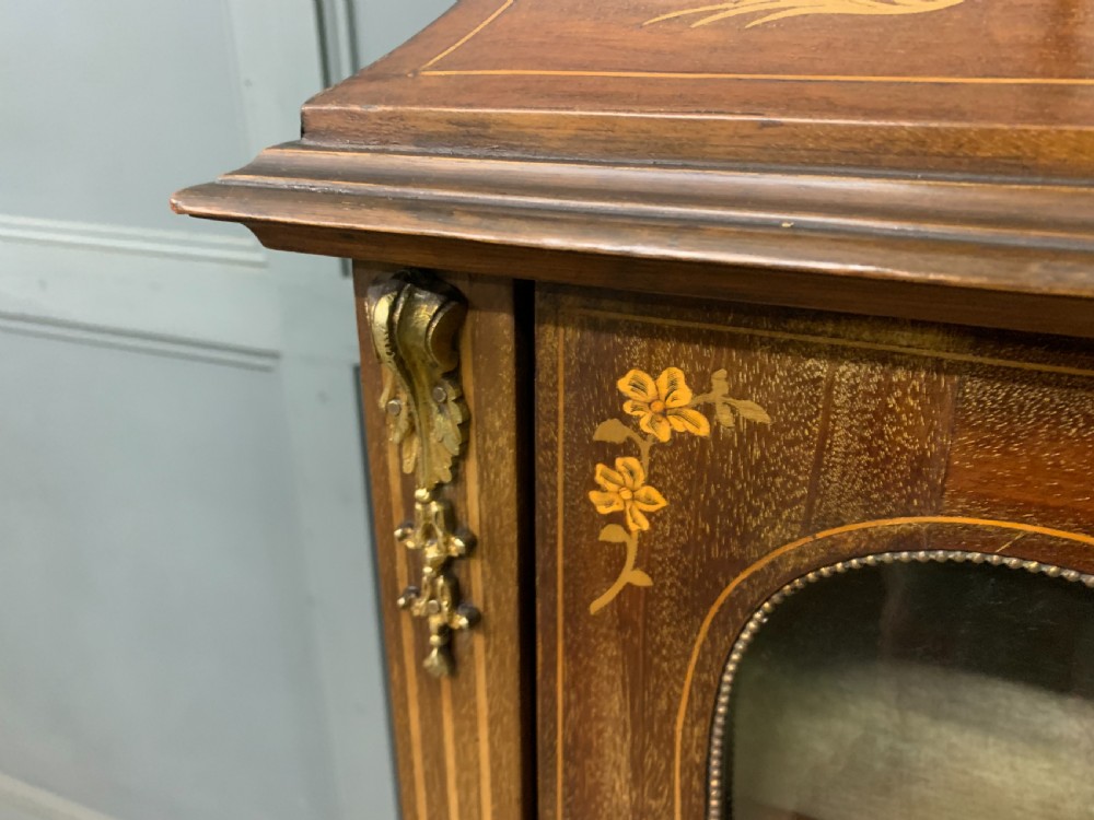 A freestanding mahogany vitrine featuring floral marquetry, a single glazed door, a brass top gallery, and cabriole legs with metal mounts. View VIII