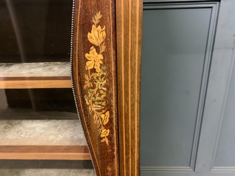 A freestanding mahogany vitrine featuring floral marquetry, a single glazed door, a brass top gallery, and cabriole legs with metal mounts. View XI