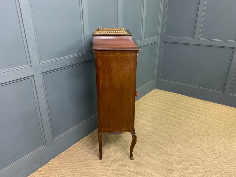A freestanding mahogany vitrine featuring floral marquetry, a single glazed door, a brass top gallery, and cabriole legs with metal mounts. View XIII