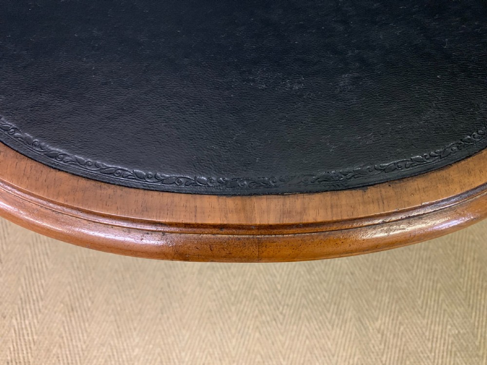 A French walnut drop-leaf table featuring cabriole legs with carved knee foliage and a black inset leather top surface. View XVIII
