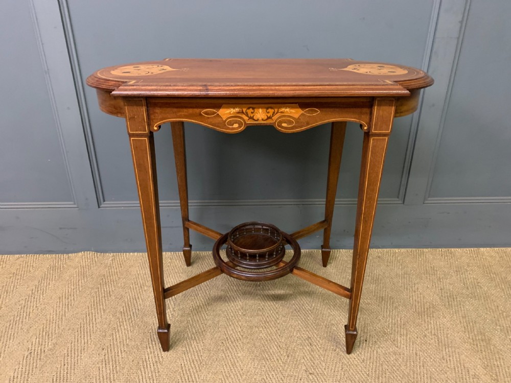 An Edwardian mahogany occasional table featuring intricate floral marquetry top inlays, tapered legs, and a central circular spindled undertier. View II