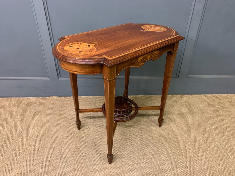 An Edwardian mahogany occasional table featuring intricate floral marquetry top inlays, tapered legs, and a central circular spindled undertier. View VIII