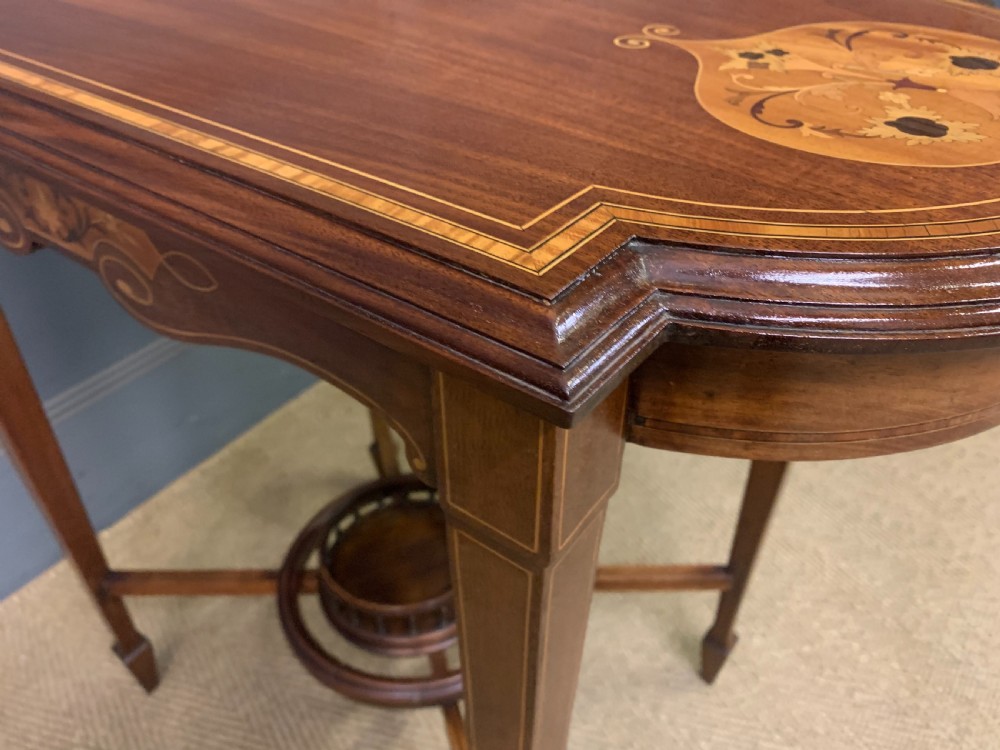 An Edwardian mahogany occasional table featuring intricate floral marquetry top inlays, tapered legs, and a central circular spindled undertier. View XII