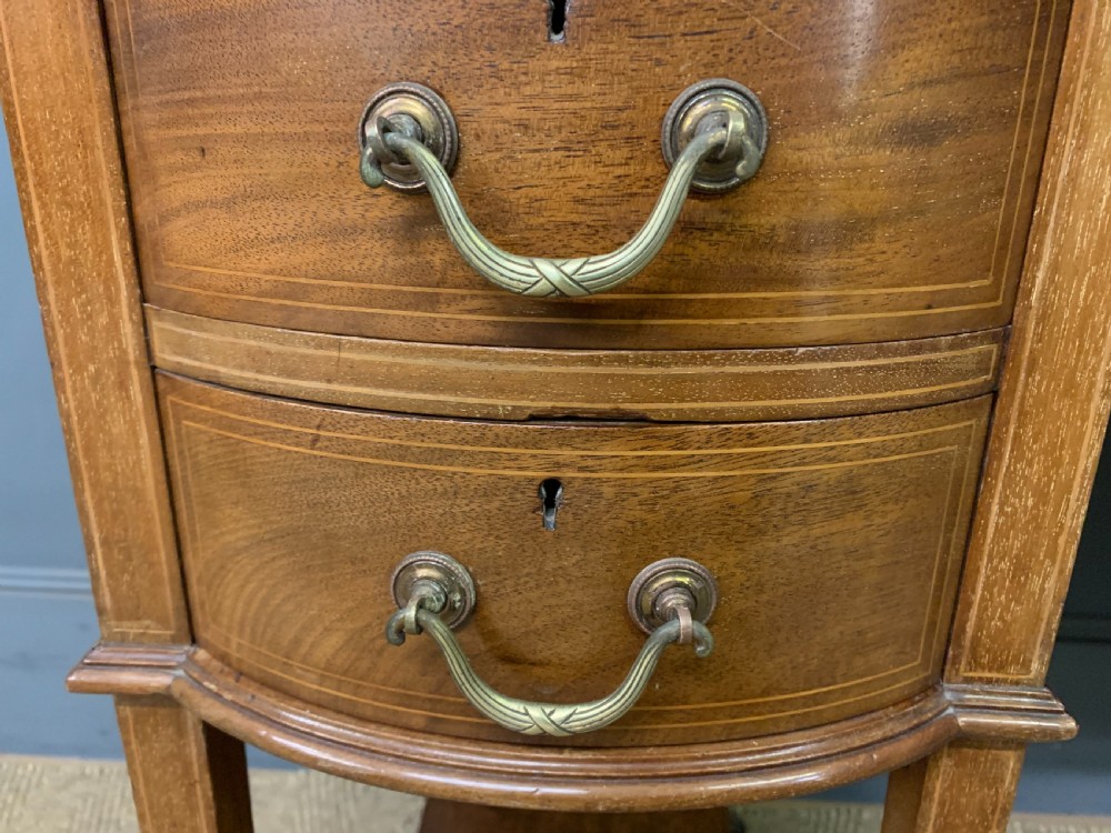 An Edwardian mahogany writing desk featuring a green leather surface, brass gallery rail, marquetry sloped panels, and drawer pedestals on tapered legs. View X