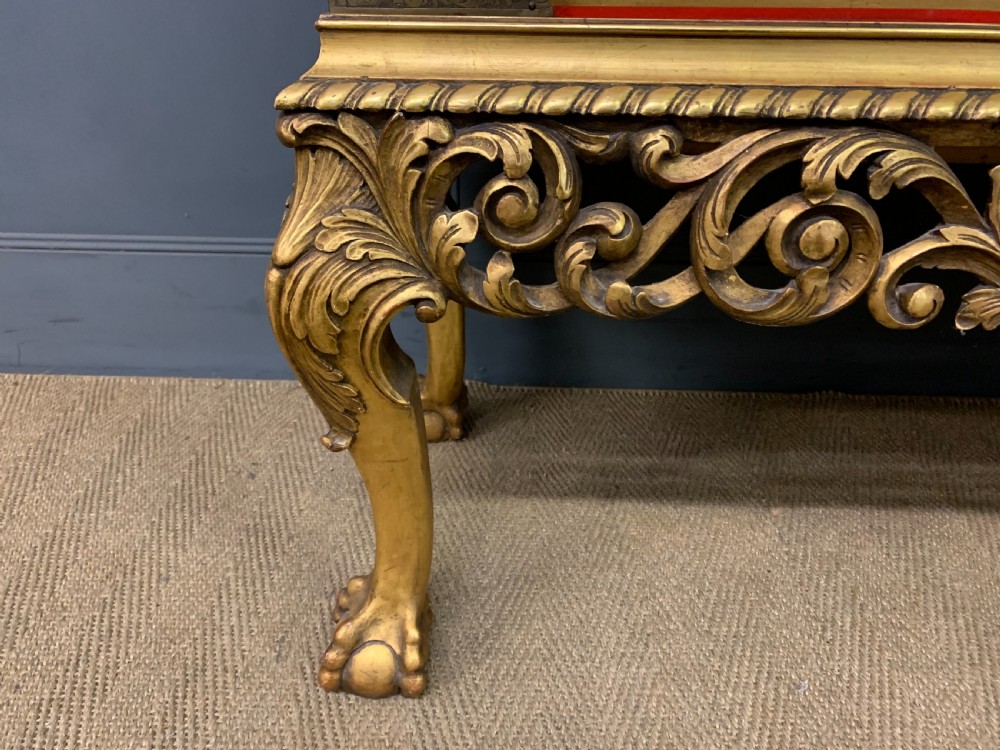 A bright red lacquered Chinoiserie cabinet with gold hand-painted figures and landscapes, mounted on an ornate carved giltwood stand with cabriole legs. View XIII