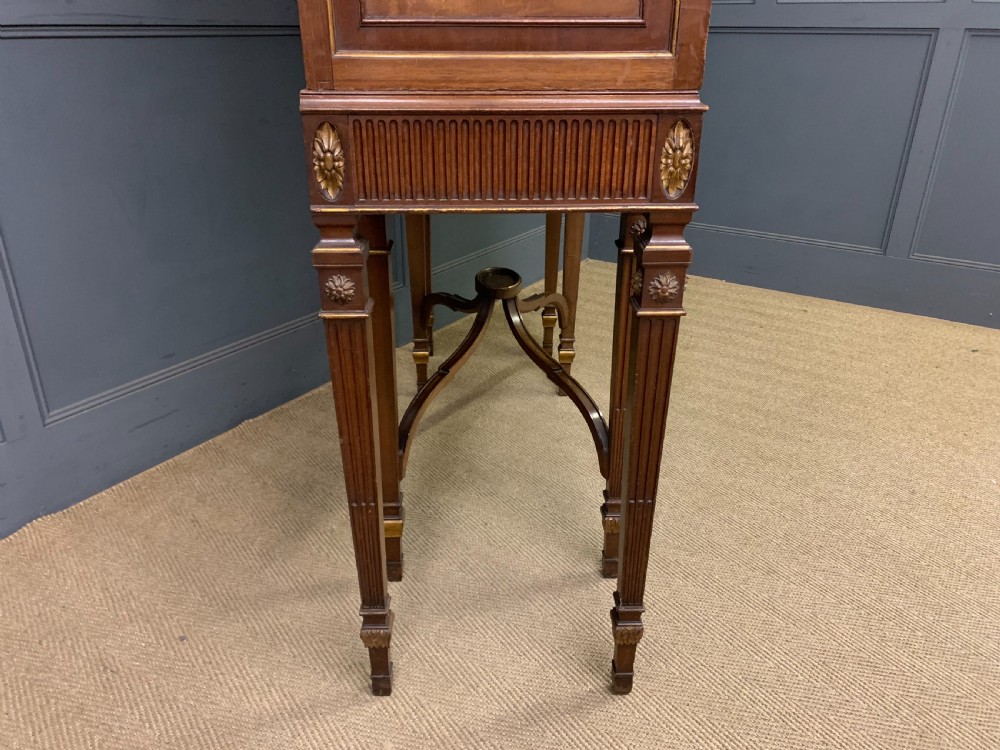 An antique mahogany display cabinet featuring glazed centre doors, side inlaid panels, fluted legs, and an arched top. View XXIV