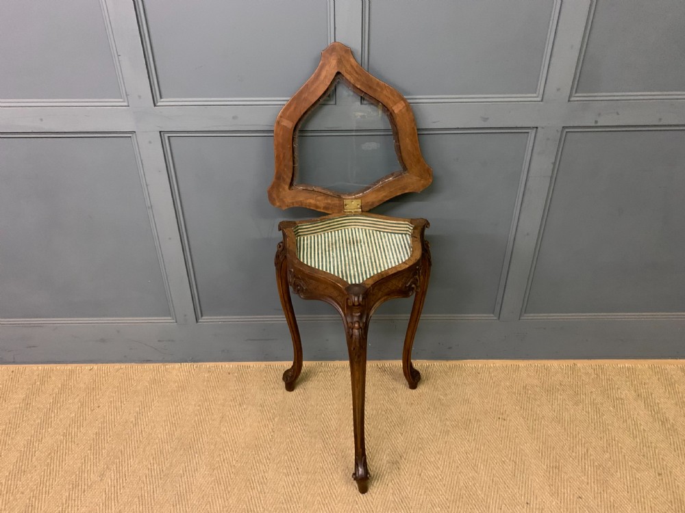 A French carved walnut bijouterie table featuring a trefoil-shaped hinged glass top, cabriole legs, and a striped fabric interior lining. View IV