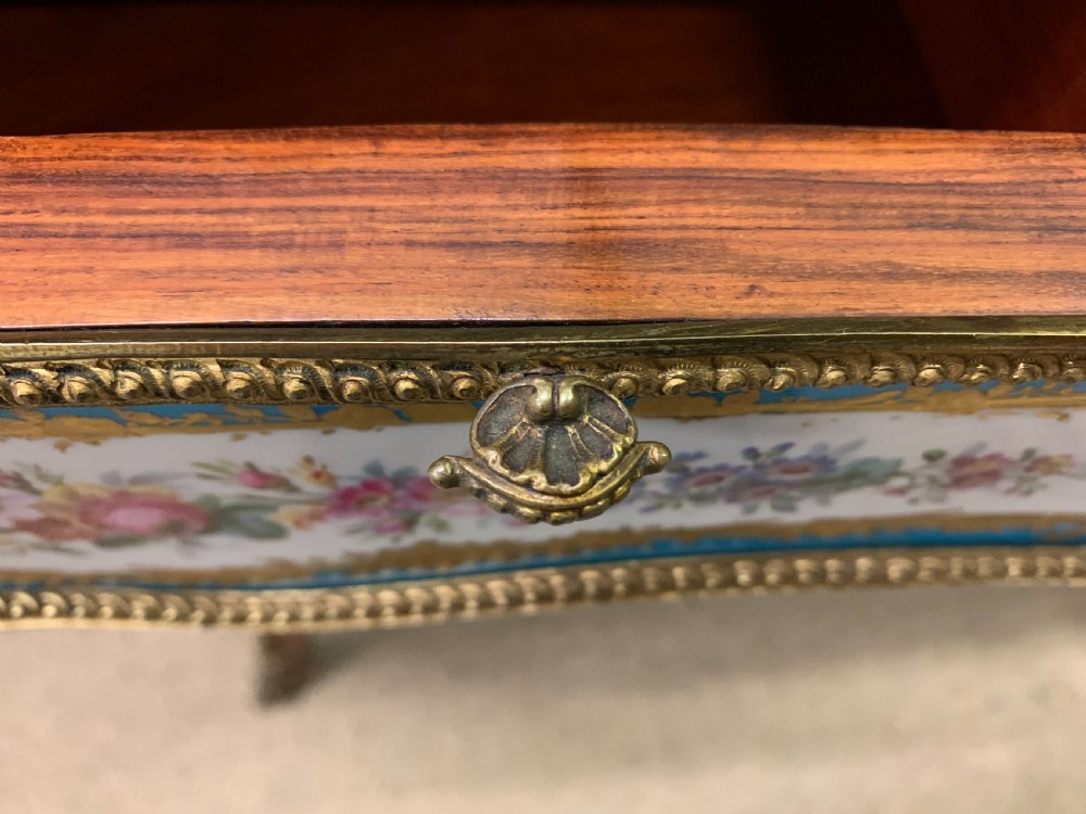 An antique Louis XV style French tulipwood bureau plat featuring a leather-inset top, gilt-bronze mounts, cabriole legs, and hand-painted porcelain plaques. View XXII