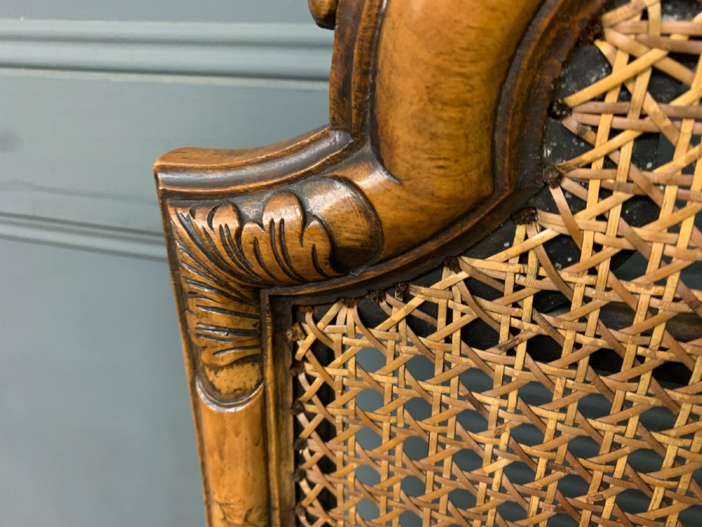 A pair of carved walnut side chairs with tall woven cane backs, floral tapestry upholstered seats, and scroll legs. View VIII