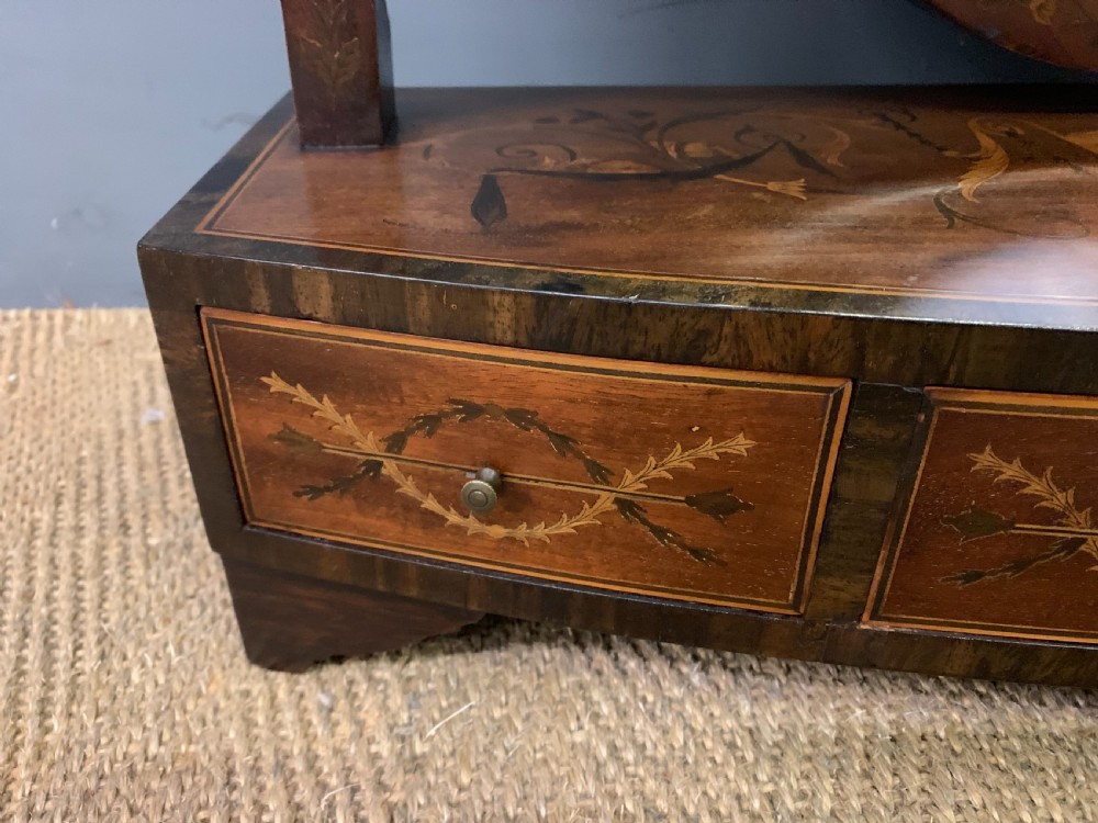 A Georgian mahogany toilet mirror featuring a shield-shaped swing frame, inlaid satinwood urn motifs, and a drawer base with curved fronting. View VI