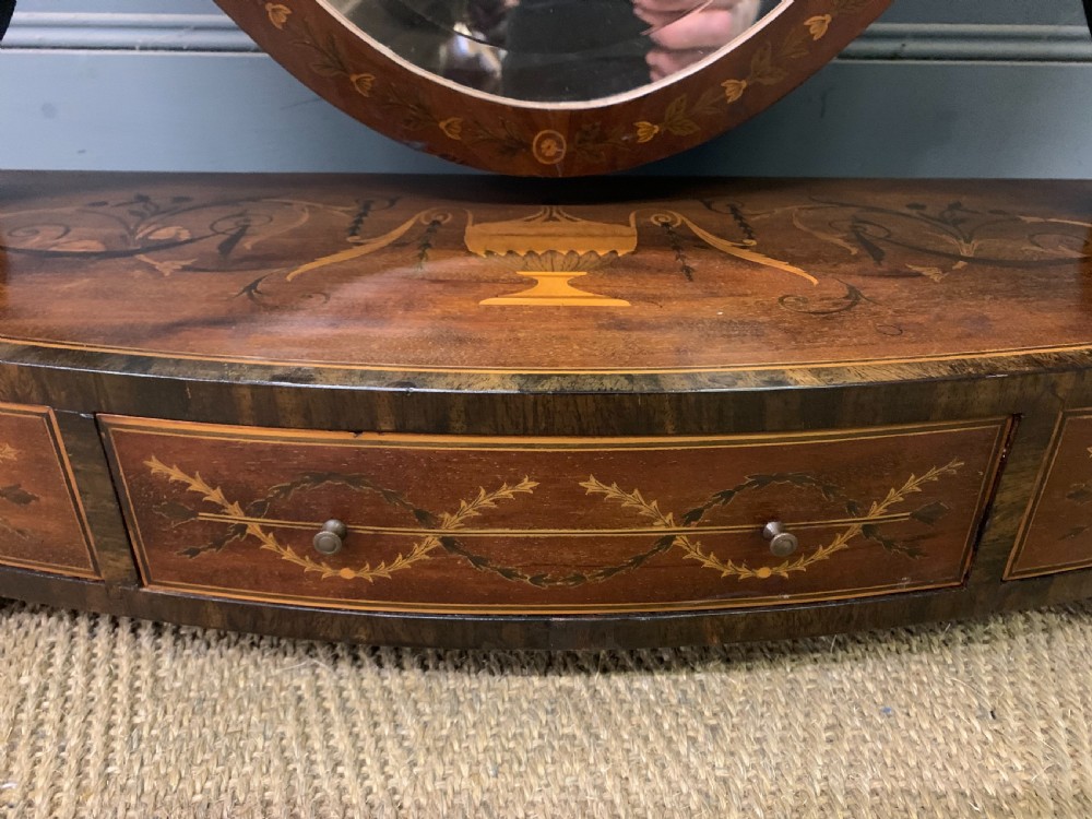 A Georgian mahogany toilet mirror featuring a shield-shaped swing frame, inlaid satinwood urn motifs, and a drawer base with curved fronting. View VII