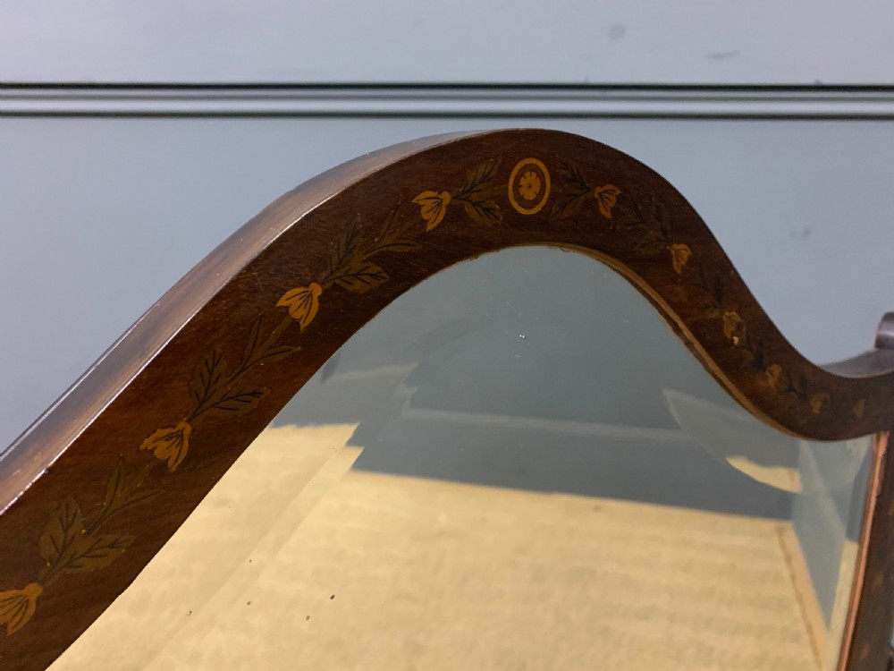 A Georgian mahogany toilet mirror featuring a shield-shaped swing frame, inlaid satinwood urn motifs, and a drawer base with curved fronting. View IX