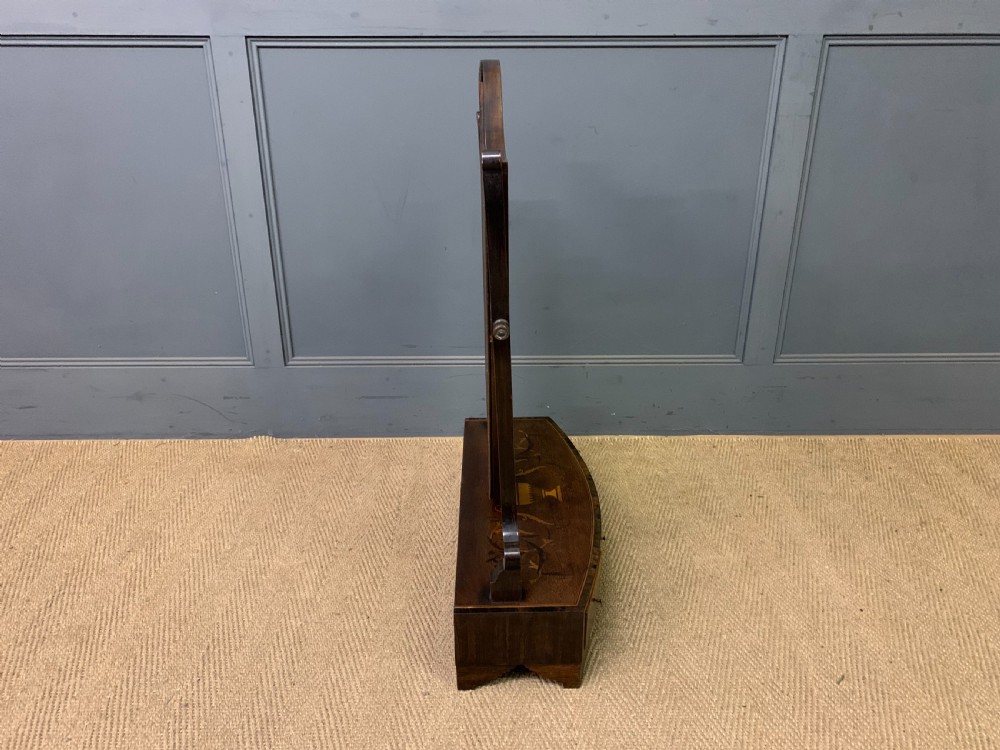 A Georgian mahogany toilet mirror featuring a shield-shaped swing frame, inlaid satinwood urn motifs, and a drawer base with curved fronting. View XII