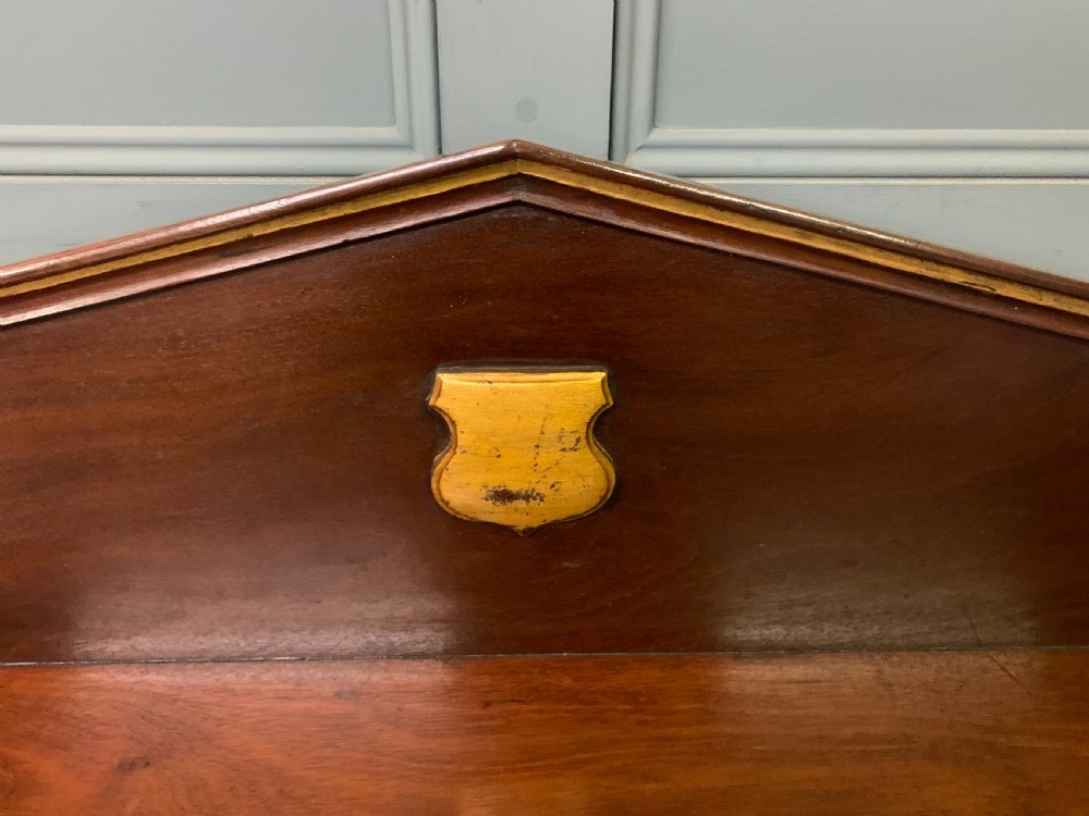 A dark mahogany Victorian hall table featuring spiral turned legs with gold accents, a scalloped apron, and an elevated gallery back with a central brass crest. View VI
