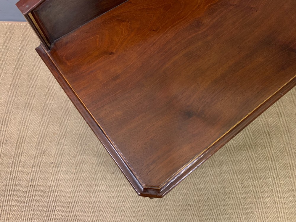 A dark mahogany Victorian hall table featuring spiral turned legs with gold accents, a scalloped apron, and an elevated gallery back with a central brass crest. View XIV