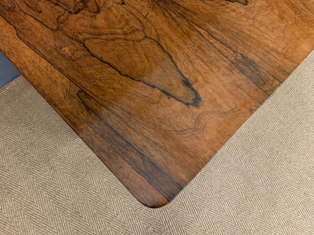 A William IV rosewood Sutherland table featuring folded drop-leaf sides, turned supports, and platform feet with castors. View XV