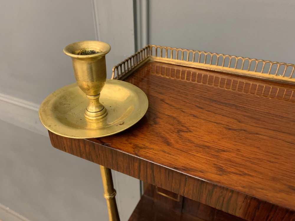 An antique Regency rosewood chiffonier featuring ornate brass inlay, a top mirror back with a brass gallery rail, and twin doors with brass wire mesh. View IV