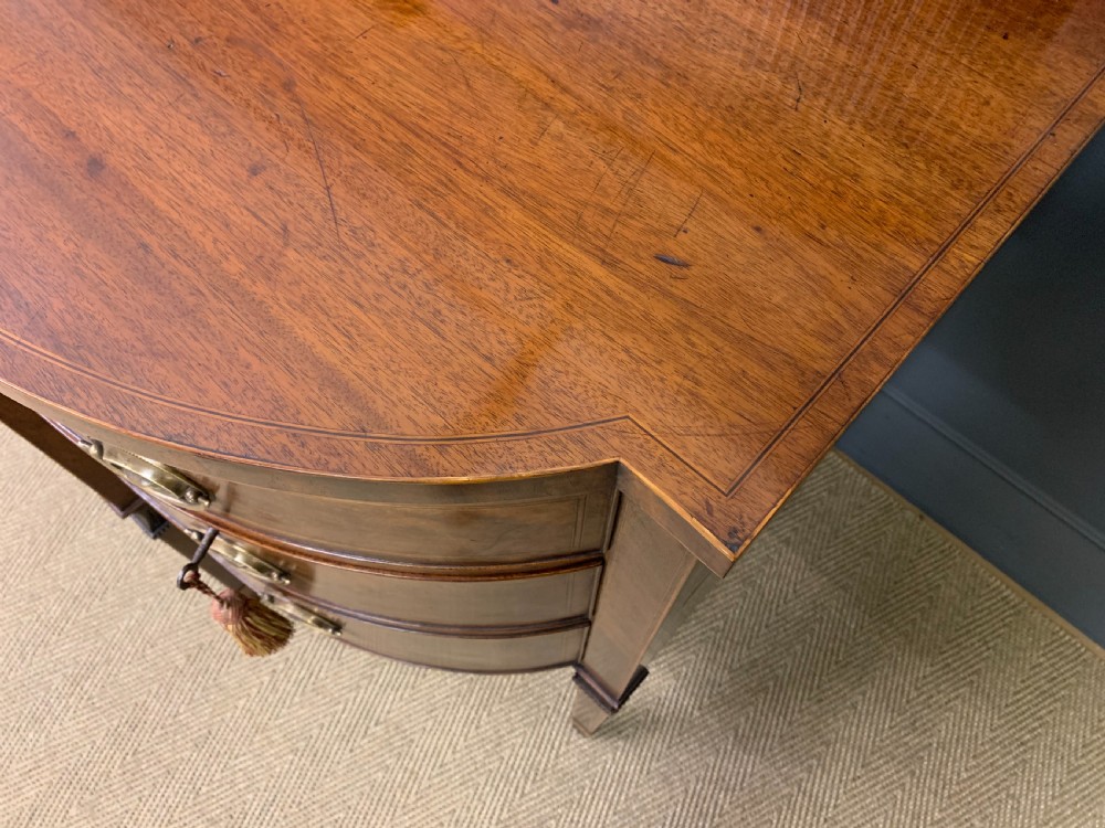 An antique George III inlaid mahogany sideboard with flame wood veneers, tambour doors, and brass ring drawer handles. View XI