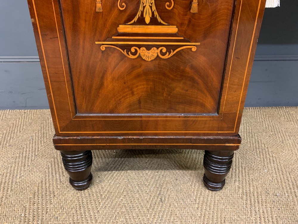 A George III inlaid mahogany pedestal sideboard featuring twin cupboard pedestals decorated with urn marquetry and a shaped backboard. View VII