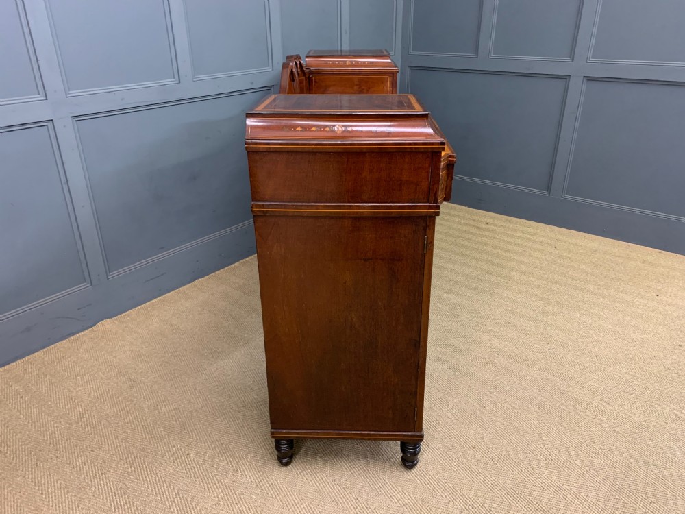 A George III inlaid mahogany pedestal sideboard featuring twin cupboard pedestals decorated with urn marquetry and a shaped backboard. View XXI