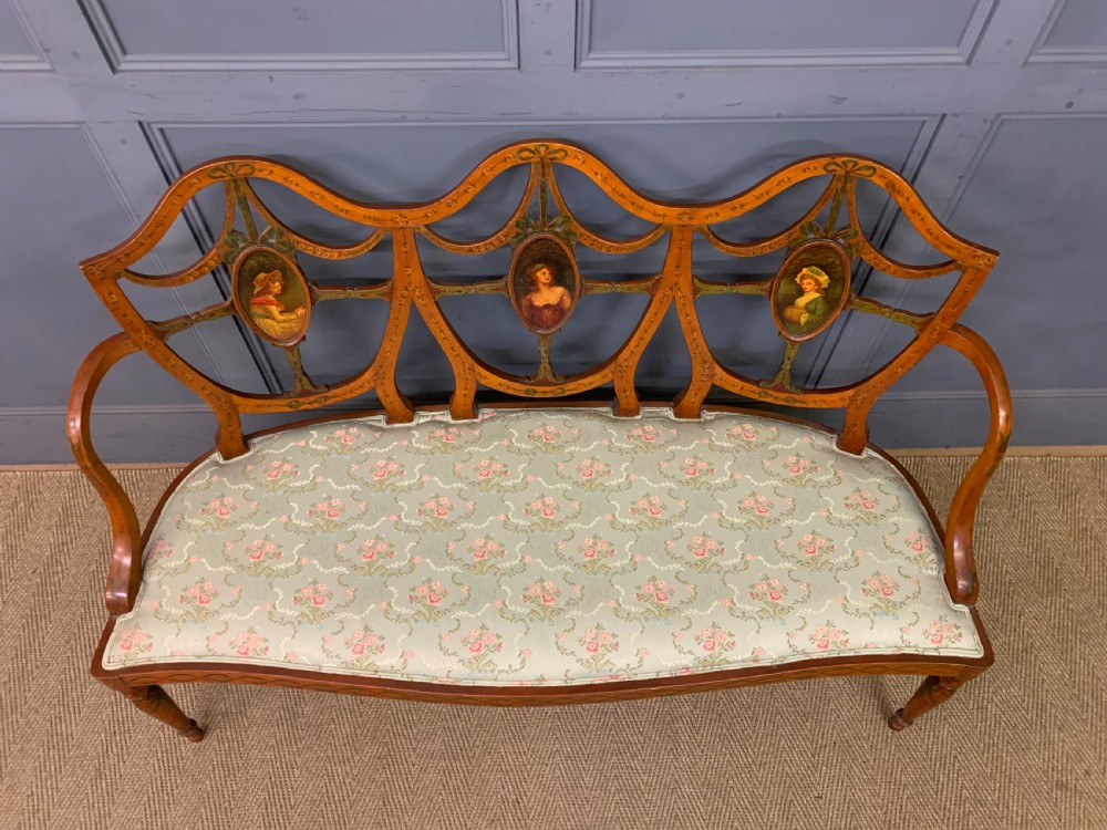 A painted satinwood three-seat settee with central portrait medallions and a light green floral upholstered cushion. View VIII