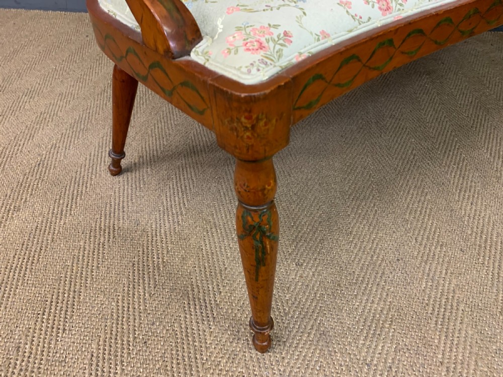 A painted satinwood three-seat settee with central portrait medallions and a light green floral upholstered cushion. View XII