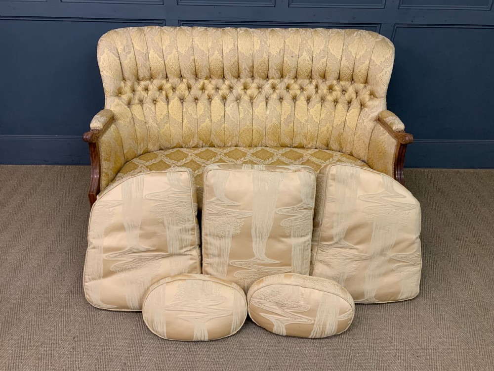 A three-piece French walnut salon suite featuring a sofa and two matching armchairs upholstered in gold patterned damask with deep buttoned backrests and fluted carved legs. View VIII