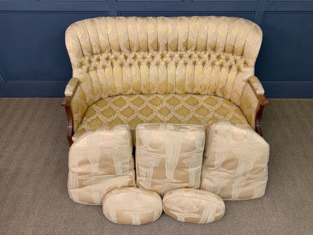 A three-piece French walnut salon suite featuring a sofa and two matching armchairs upholstered in gold patterned damask with deep buttoned backrests and fluted carved legs. View IX