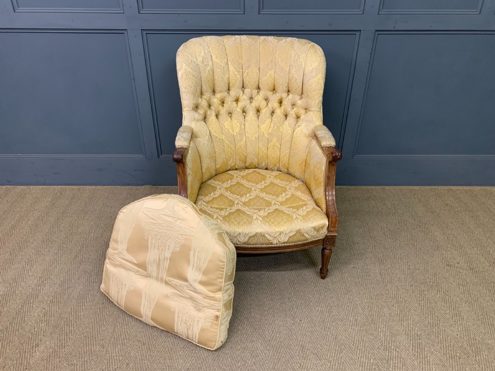 A three-piece French walnut salon suite featuring a sofa and two matching armchairs upholstered in gold patterned damask with deep buttoned backrests and fluted carved legs. View XXI